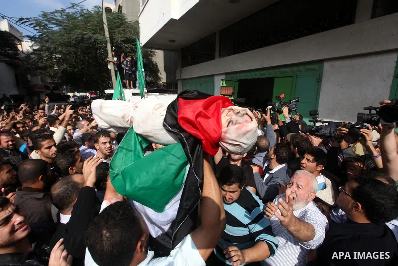 Palestinians carry the bodies of civilian from the al-Dallu family during their funeral in Gaza City, on November 19, 2012.Eleven members of the al-Dallu family were killed on Sunday when an Israeli missile struck the tw...
