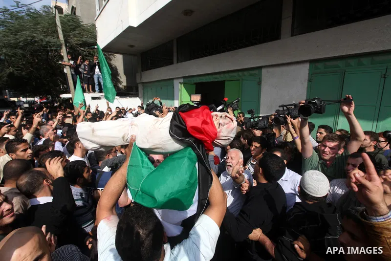 Palestinians carry the bodies of civilian from the al-Dallu family during their funeral in Gaza City, on November 19, 2012.Eleven members of the al-Dallu family were killed on Sunday when an Israeli missile struck the tw...