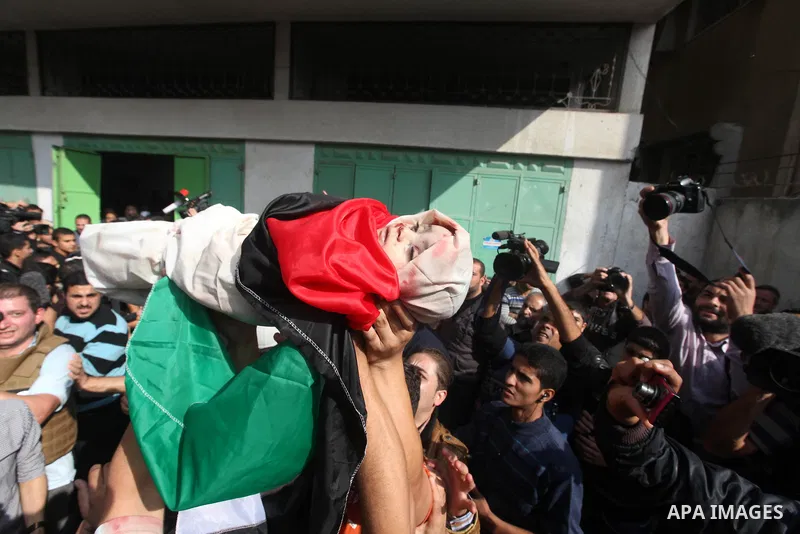 Palestinians carry the bodies of civilian from the al-Dallu family during their funeral in Gaza City, on November 19, 2012.Eleven members of the al-Dallu family were killed on Sunday when an Israeli missile struck the tw...