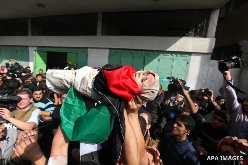 Palestinians carry the bodies of civilian from the al-Dallu family during their funeral in Gaza City, on November 19, 2012.Eleven members of the al-Dallu family were killed on Sunday when an Israeli missile struck the tw...