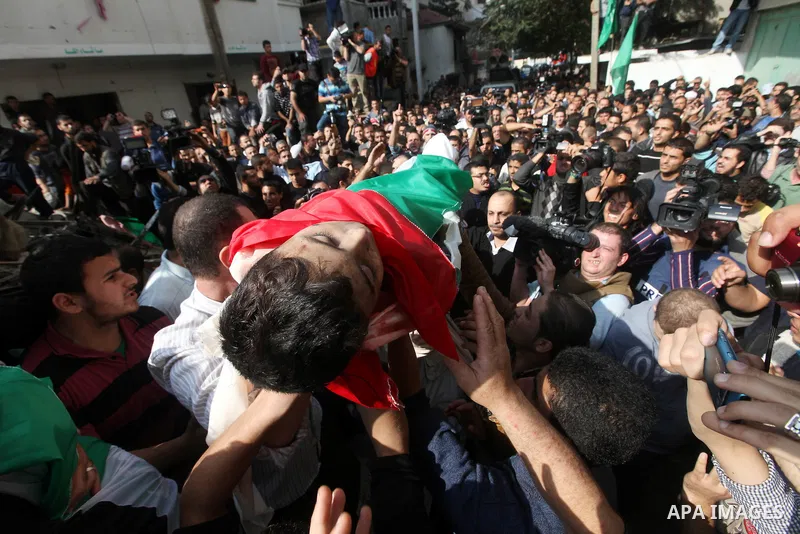 Palestinians carry the bodies of civilian from the al-Dallu family during their funeral in Gaza City, on November 19, 2012.Eleven members of the al-Dallu family were killed on Sunday when an Israeli missile struck the tw...