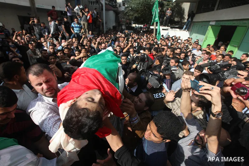 Palestinians carry the bodies of civilian from the al-Dallu family during their funeral in Gaza City, on November 19, 2012.Eleven members of the al-Dallu family were killed on Sunday when an Israeli missile struck the tw...