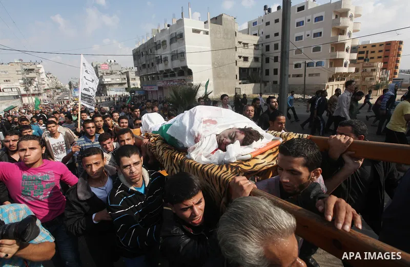 Palestinians carry the bodies of the al-Dallu family during their funeral in Gaza City, 19 November 2012. Nine members of the al-Dallu family died when Israeli forced hit their building in Gaza City one day ago. Media re...