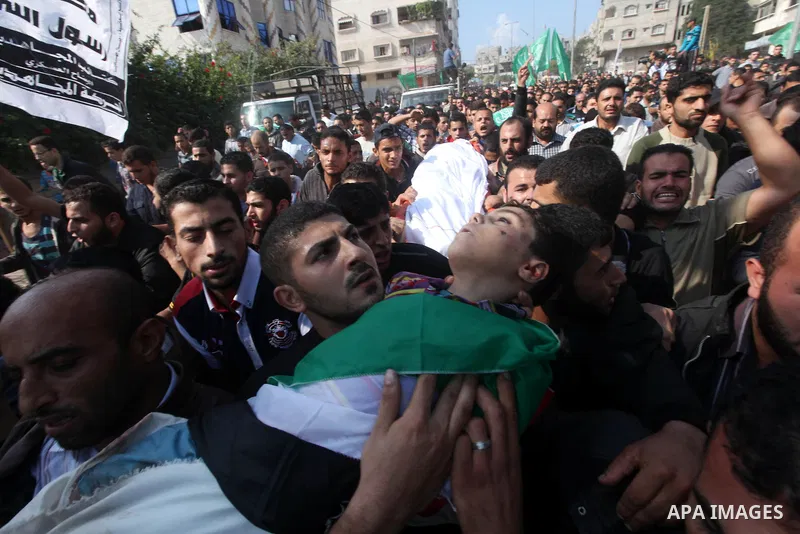 Palestinians carry the bodies of the al-Dallu family during their funeral in Gaza City, 19 November 2012. Nine members of the al-Dallu family died when Israeli forced hit their building in Gaza City one day ago. Media re...