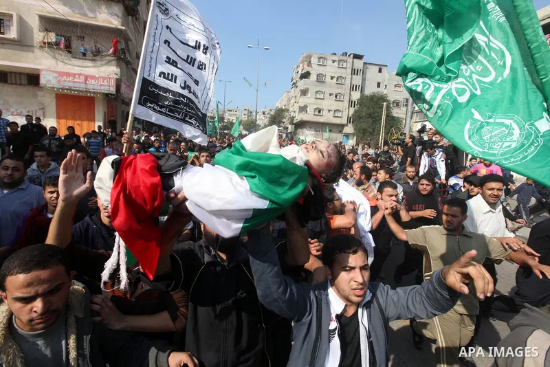 Palestinians carry the bodies of the al-Dallu family during their funeral in Gaza City, 19 November 2012. Nine members of the al-Dallu family died when Israeli forced hit their building in Gaza City one day ago. Media re...
