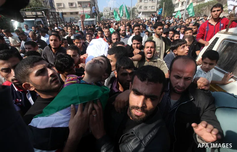 Palestinians carry the bodies of the al-Dallu family during their funeral in Gaza City, 19 November 2012. Nine members of the al-Dallu family died when Israeli forced hit their building in Gaza City one day ago. Media re...