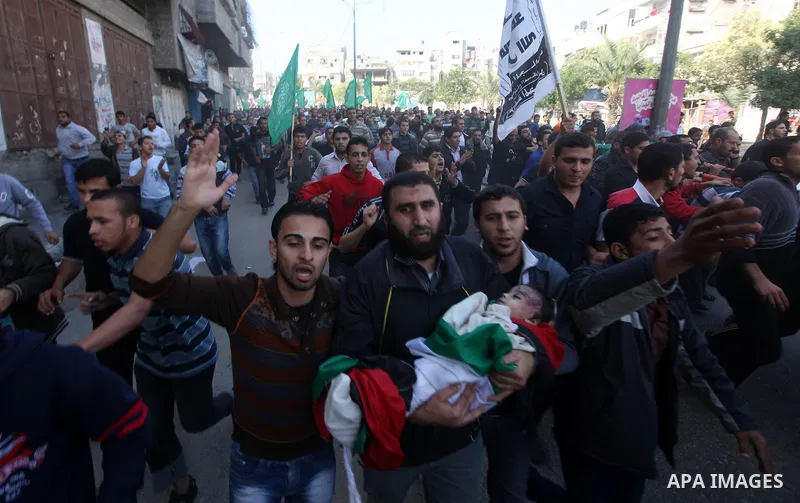 Palestinians carry the bodies of the al-Dallu family during their funeral in Gaza City, 19 November 2012. Nine members of the al-Dallu family died when Israeli forced hit their building in Gaza City one day ago. Media re...