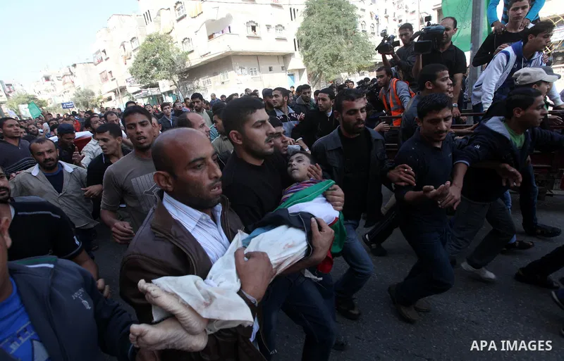 Palestinians carry the bodies of the al-Dallu family during their funeral in Gaza City, 19 November 2012. Nine members of the al-Dallu family died when Israeli forced hit their building in Gaza City one day ago. Media re...