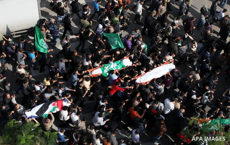 Palestinians carry the bodies of the al-Dallu family during their funeral in Gaza City, 19 November 2012. Nine members of the al-Dallu family died when Israeli forced hit their building in Gaza City one day ago. Media re...