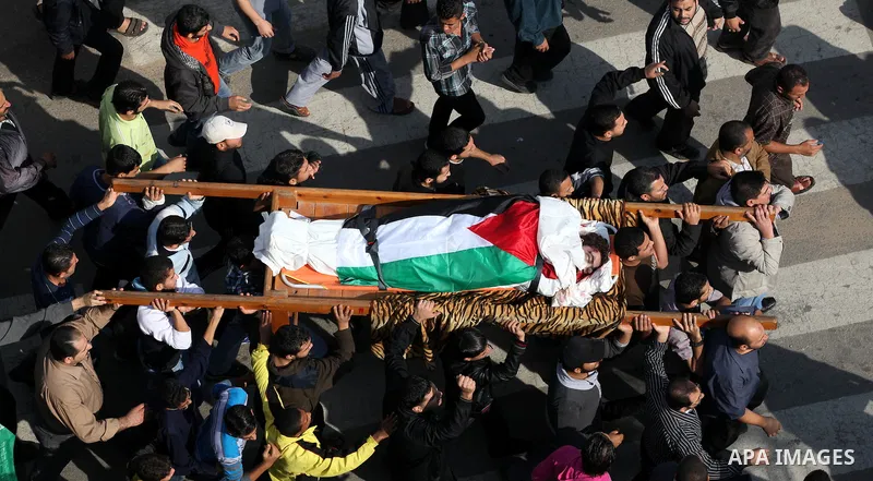 Palestinians carry the bodies of the al-Dallu family during their funeral in Gaza City, 19 November 2012. Nine members of the al-Dallu family died when Israeli forced hit their building in Gaza City one day ago. Media re...