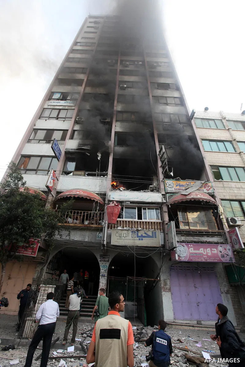 Palestinians inspect the damage after an Israeli air strike on al-Shorooq building in Gaza city, 19 November, 2012. Media reports that Israeli forces were on Monday targeting the Palestinian homes and other buildings in...