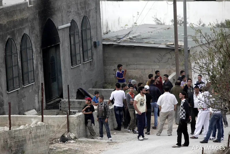 Palestinians gather near a mosque during a protest against burning mosques in the West Bank city of Nablus, 19 November 2012. Jewish settlers Monday set fire to al-Ribat mosque in Orif village, burning out the carpets, a...