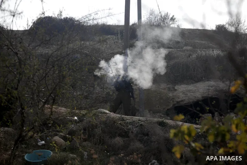 Israeli soldiers fire tear gas at Palestinian protesters during protest against burning mosques in the West Bank city of Nablus, 19 November 2012. Jewish settlers Monday set fire to al-Ribat mosque in Orif village, burni...