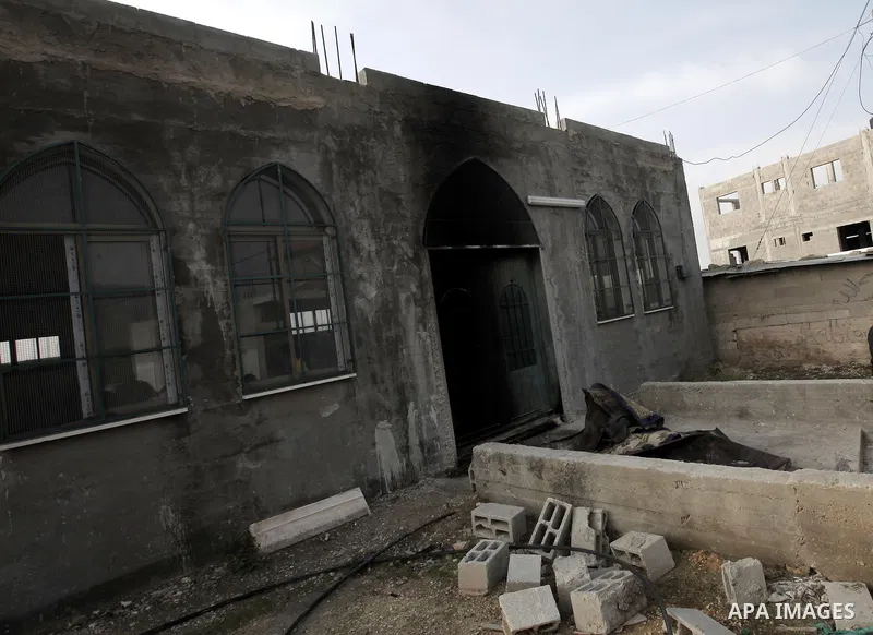 Palestinians gather near a mosque during a protest against burning mosques in the West Bank city of Nablus, 19 November 2012. Jewish settlers Monday set fire to al-Ribat mosque in Orif village, burning out the carpets, a...