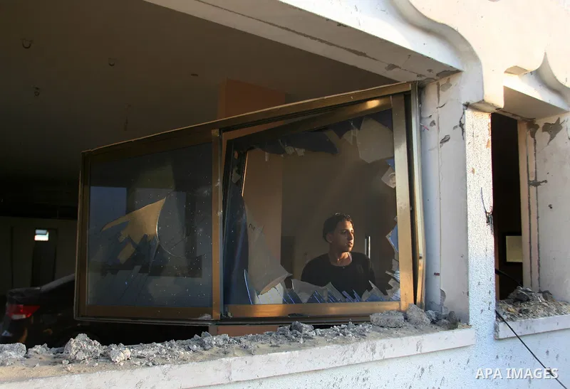 Palestinians inspect the damage after an Israeli air strike in Rafah in southern Gaza strip, 19 November, 2012. Media reports that Israeli forces were on Monday targeting the Palestinian homes and other buildings in its...