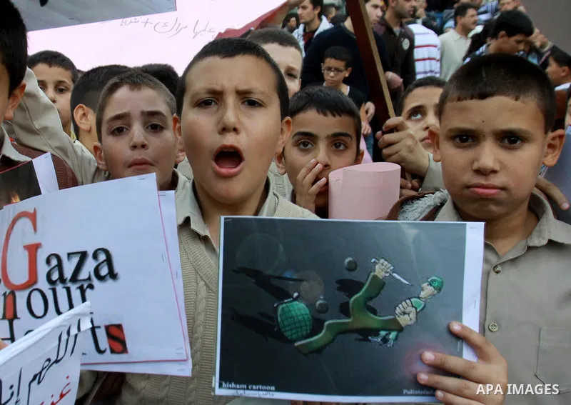 Palestinian children shout slogans during a protest against Israeli military operation in the Gaza Strip, in the West Bank city of Nablus, November 19, 2012. Photo by Nedal Eshtayah