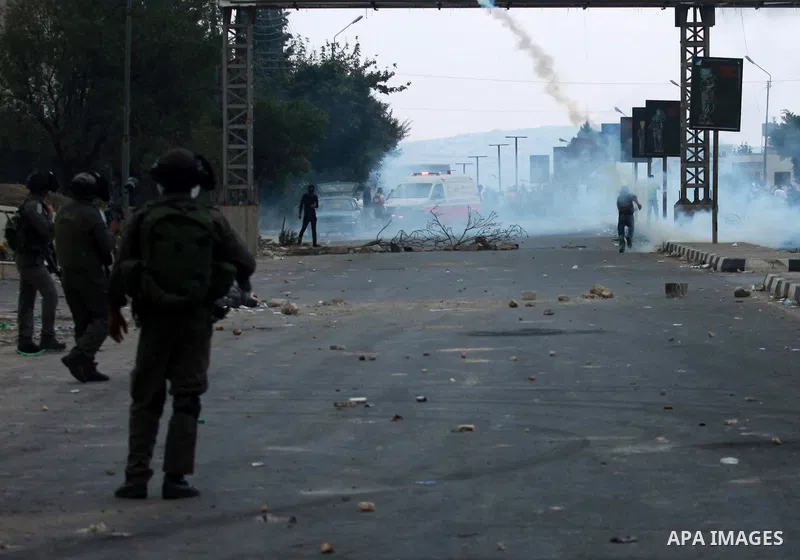 Israeli soldiers fire tear gas at Palestinian protester during clashes against Israel's military operation in the Gaza Strip, in the West Bank city of Nablus on November 19, 2012. Israeli air strikes killed 22 Palestinia...