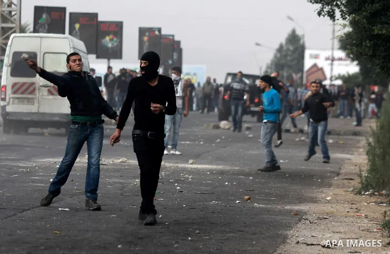 Palestinian protesters throw stones at Israeli soldiers during clashes against Israel's military operation in the Gaza Strip, in the West Bank city of Nablus on November 19, 2012. Israeli air strikes killed 22 Palestinia...