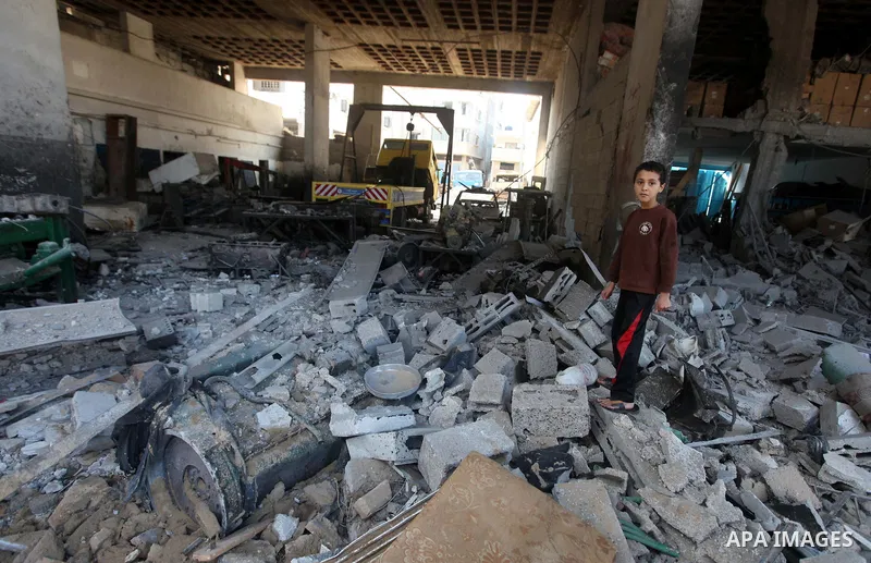 Palestinian boys salvage baggage from a building destroyed by an Israeli airstrike, in Gaza City, Gaza Strip, 20 November 2012. Media reports state that Israel pounded more than 100 targets in Gaza on the seventh day of...