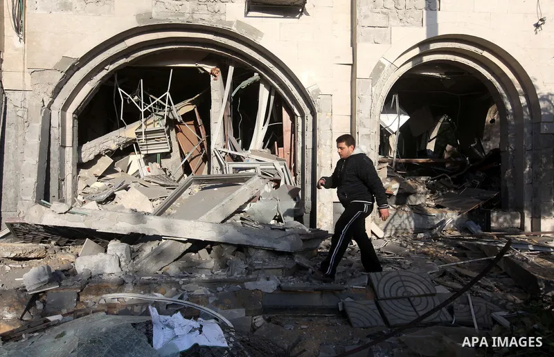 Palestinians inspect the damage after an Israeli air strike on the Islamic National Bank building in Gaza City on November 20, 2012. Israeli leaders discussed an Egyptian plan for a truce with Gaza's ruling Hamas, report...
