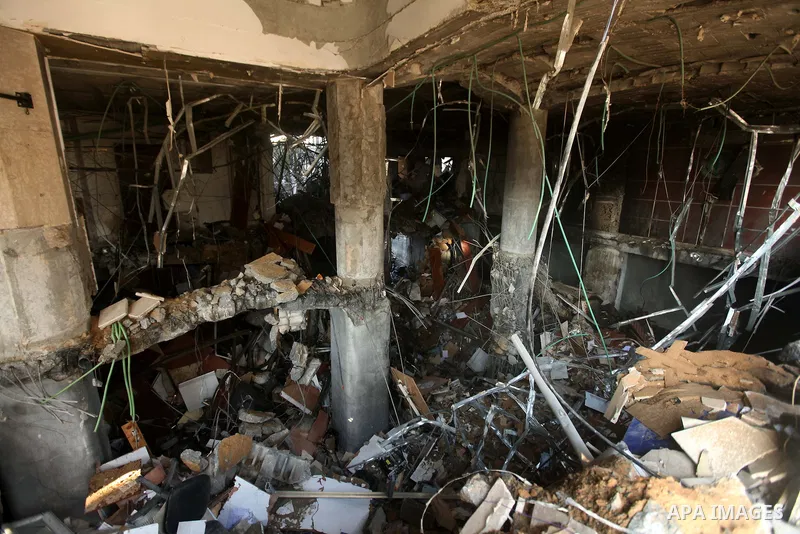 Palestinians inspect the damage after an Israeli air strike on the Islamic National Bank building in Gaza City on November 20, 2012. Israeli leaders discussed an Egyptian plan for a truce with Gaza's ruling Hamas, report...