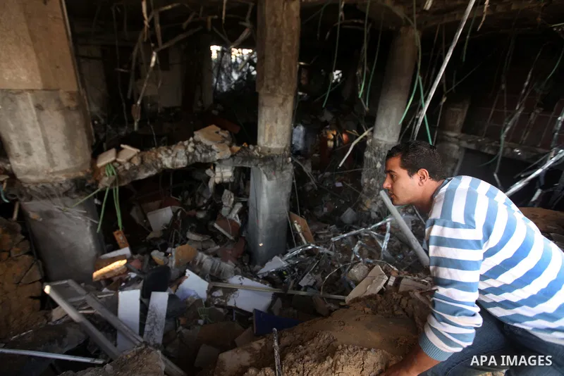 Palestinians inspect the damage after an Israeli air strike on the Islamic National Bank building in Gaza City on November 20, 2012. Israeli leaders discussed an Egyptian plan for a truce with Gaza's ruling Hamas, report...