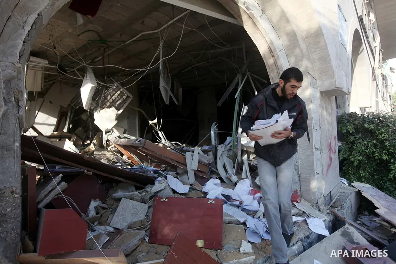 Palestinians inspect the damage after an Israeli air strike on the Islamic National Bank building in Gaza City on November 20, 2012. Israeli leaders discussed an Egyptian plan for a truce with Gaza's ruling Hamas, report...