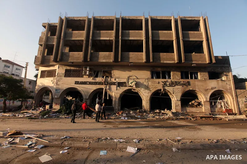 Palestinians inspect the damage after an Israeli air strike on the Islamic National Bank building in Gaza City on November 20, 2012. Israeli leaders discussed an Egyptian plan for a truce with Gaza's ruling Hamas, report...