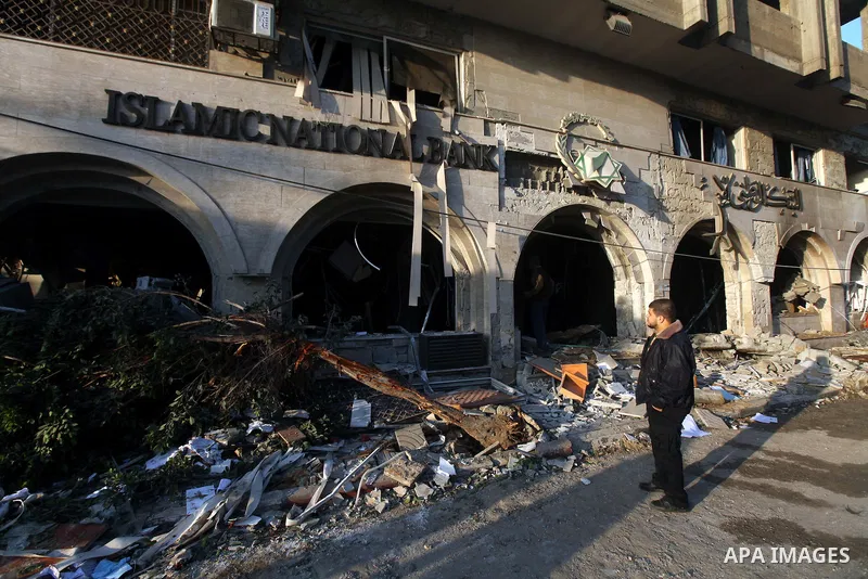 Palestinians inspect the damage after an Israeli air strike on the Islamic National Bank building in Gaza City on November 20, 2012. Israeli leaders discussed an Egyptian plan for a truce with Gaza's ruling Hamas, report...