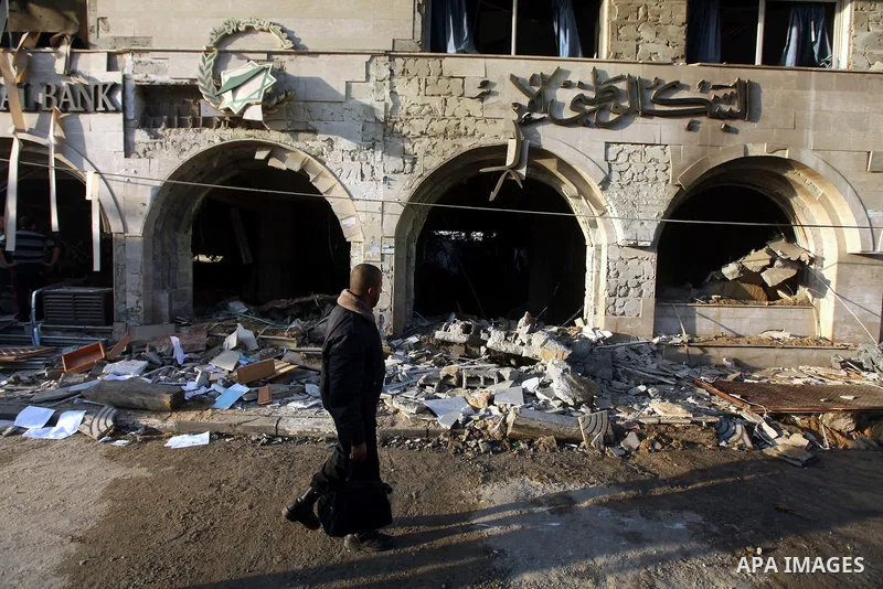 Palestinians inspect the damage after an Israeli air strike on the Islamic National Bank building in Gaza City on November 20, 2012. Israeli leaders discussed an Egyptian plan for a truce with Gaza's ruling Hamas, report...