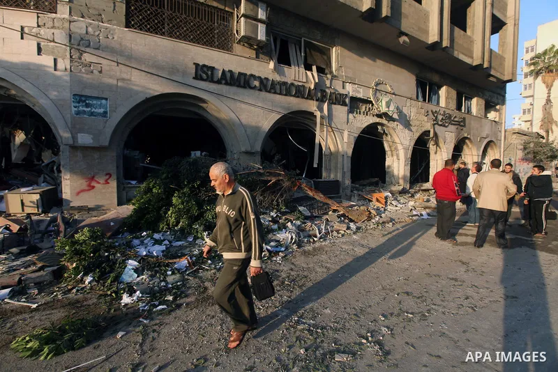 Palestinians inspect the damage after an Israeli air strike on the Islamic National Bank building in Gaza City on November 20, 2012. Israeli leaders discussed an Egyptian plan for a truce with Gaza's ruling Hamas, report...