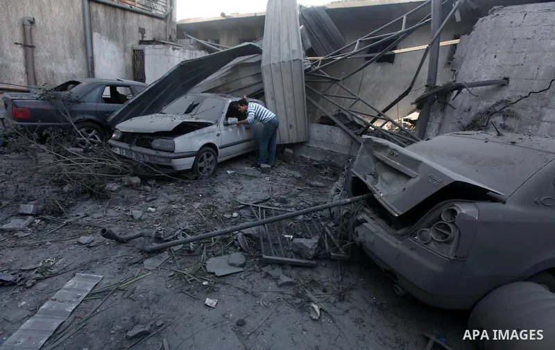 Palestinians inspect the damage after an Israeli air strike on the Islamic National Bank building in Gaza City on November 20, 2012. Israeli leaders discussed an Egyptian plan for a truce with Gaza's ruling Hamas, report...