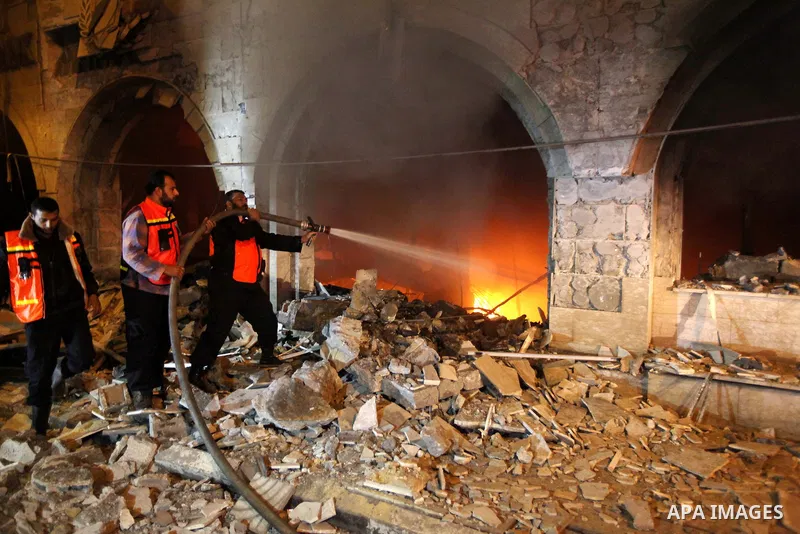 Palestinian firefighters try to extinguish a blaze after an Israeli air strike on the Islamic National Bank building in Gaza City on November 20, 2012. Israeli leaders discussed an Egyptian plan for a truce with Gaza's r...