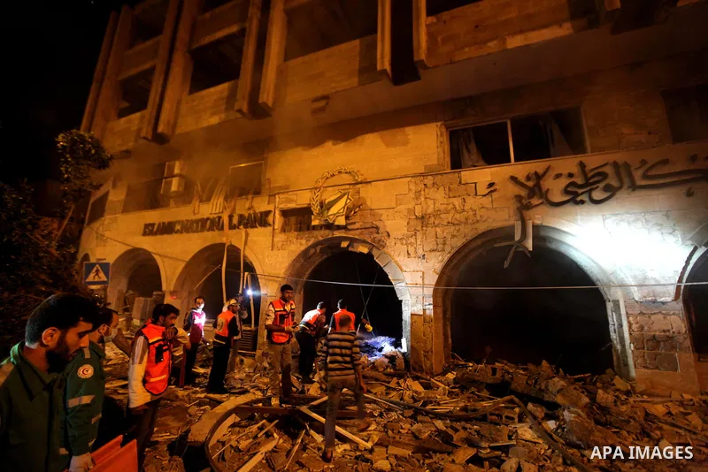 Palestinian firefighters try to extinguish a blaze after an Israeli air strike on the Islamic National Bank building in Gaza City on November 20, 2012. Israeli leaders discussed an Egyptian plan for a truce with Gaza's r...