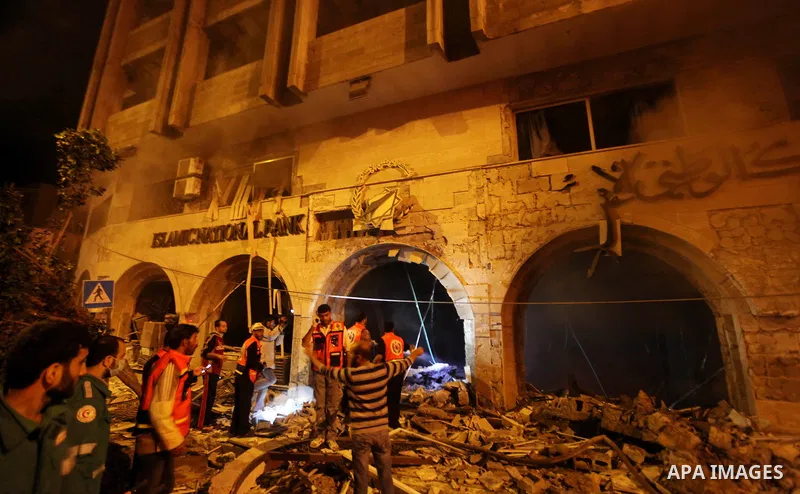 Palestinian firefighters try to extinguish a blaze after an Israeli air strike on the Islamic National Bank building in Gaza City on November 20, 2012. Israeli leaders discussed an Egyptian plan for a truce with Gaza's r...
