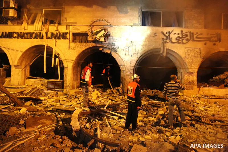 Palestinian firefighters try to extinguish a blaze after an Israeli air strike on the Islamic National Bank building in Gaza City on November 20, 2012. Israeli leaders discussed an Egyptian plan for a truce with Gaza's r...