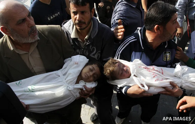 Palestinians carry the bodies of brothers Suhaib, 2-years-old, and Mohammed Hejazi, 4-years-old, during their funeral in the northern Gaza Strip area of Biet Lahia, on November 20, 2012. Four members of the Hejazi family...