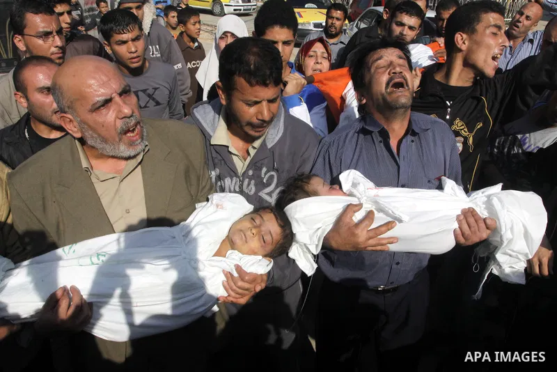 Palestinians carry the bodies of brothers Suhaib, 2-years-old, and Mohammed Hejazi, 4-years-old, during their funeral in the northern Gaza Strip area of Biet Lahia, on November 20, 2012. Four members of the Hejazi family...