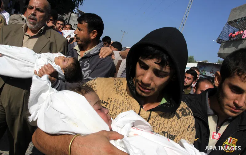 Palestinians carry the bodies of brothers Suhaib, 2-years-old, and Mohammed Hejazi, 4-years-old, during their funeral in the northern Gaza Strip area of Biet Lahia, on November 20, 2012. Four members of the Hejazi family...