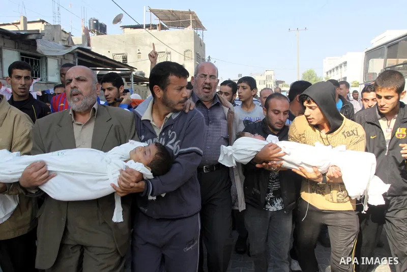 Palestinians carry the bodies of brothers Suhaib, 2-years-old, and Mohammed Hejazi, 4-years-old, during their funeral in the northern Gaza Strip area of Biet Lahia, on November 20, 2012. Four members of the Hejazi family...