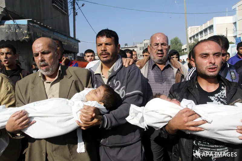 Palestinians carry the bodies of brothers Suhaib, 2-years-old, and Mohammed Hejazi, 4-years-old, during their funeral in the northern Gaza Strip area of Biet Lahia, on November 20, 2012. Four members of the Hejazi family...