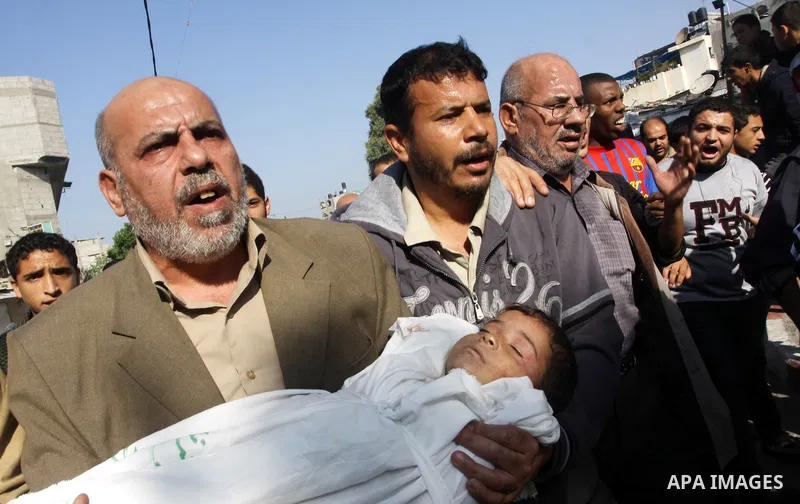 Palestinians carry the bodies of brothers Suhaib, 2-years-old, and Mohammed Hejazi, 4-years-old, during their funeral in the northern Gaza Strip area of Biet Lahia, on November 20, 2012. Four members of the Hejazi family...