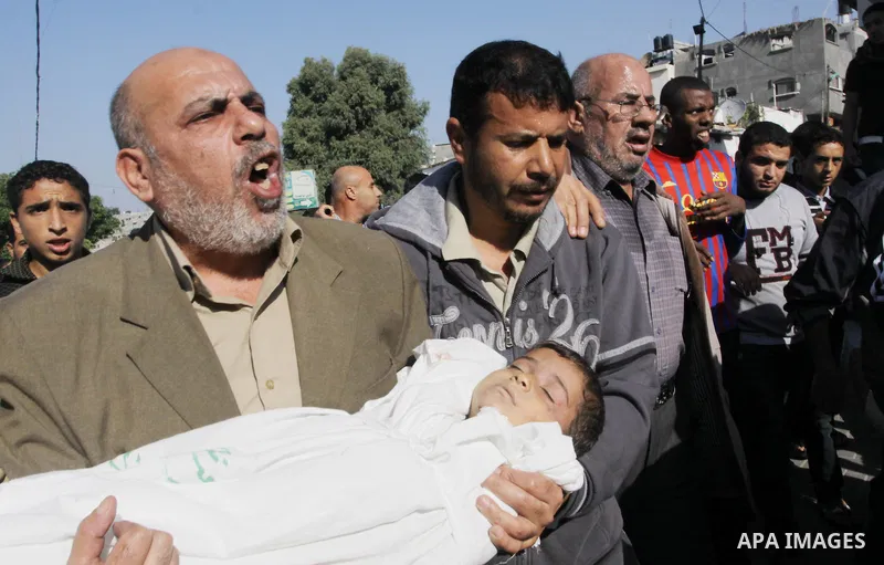 Palestinians carry the bodies of brothers Suhaib, 2-years-old, and Mohammed Hejazi, 4-years-old, during their funeral in the northern Gaza Strip area of Biet Lahia, on November 20, 2012. Four members of the Hejazi family...