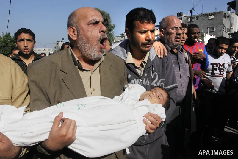 Palestinians carry the bodies of brothers Suhaib, 2-years-old, and Mohammed Hejazi, 4-years-old, during their funeral in the northern Gaza Strip area of Biet Lahia, on November 20, 2012. Four members of the Hejazi family...