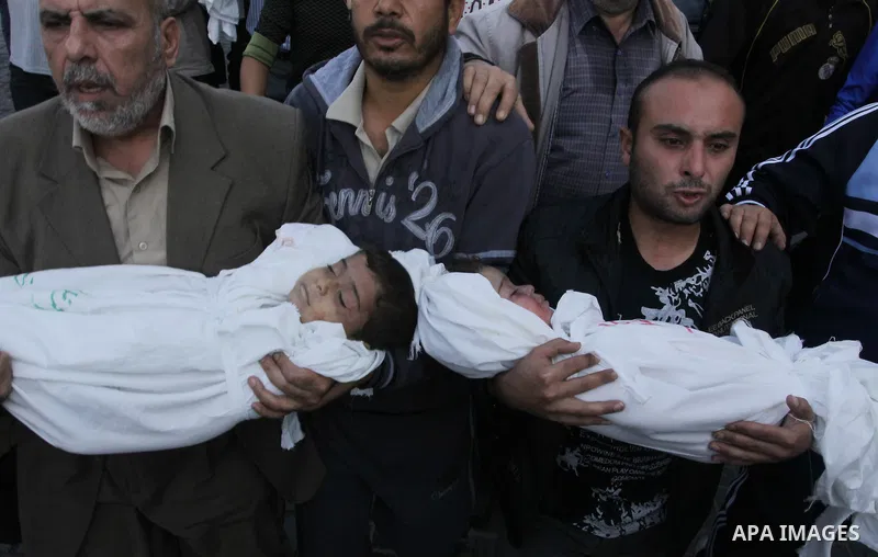 Palestinians carry the bodies of brothers Suhaib, 2-years-old, and Mohammed Hejazi, 4-years-old, during their funeral in the northern Gaza Strip area of Biet Lahia, on November 20, 2012. Four members of the Hejazi family...