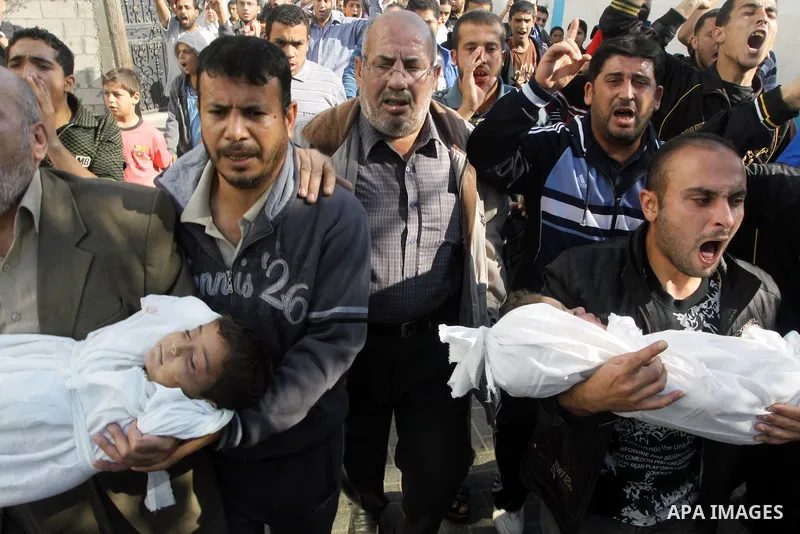 Palestinians carry the bodies of brothers Suhaib, 2-years-old, and Mohammed Hejazi, 4-years-old, during their funeral in the northern Gaza Strip area of Biet Lahia, on November 20, 2012. Four members of the Hejazi family...