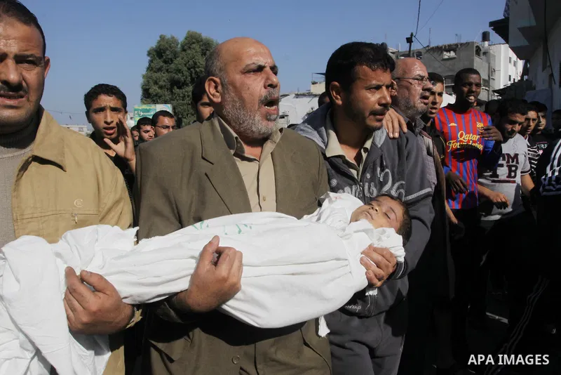 Palestinians carry the bodies of brothers Suhaib, 2-years-old, and Mohammed Hejazi, 4-years-old, during their funeral in the northern Gaza Strip area of Biet Lahia, on November 20, 2012. Four members of the Hejazi family...