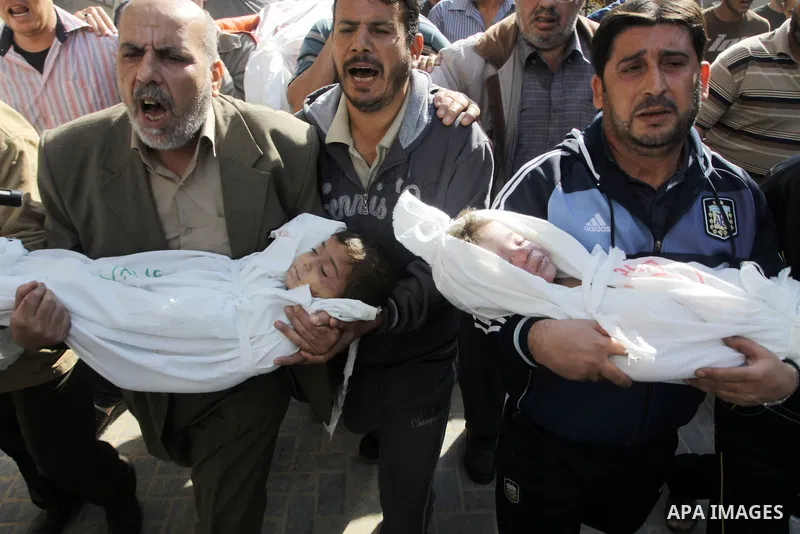 Palestinians carry the bodies of brothers Suhaib, 2-years-old, and Mohammed Hejazi, 4-years-old, during their funeral in the northern Gaza Strip area of Biet Lahia, on November 20, 2012. Four members of the Hejazi family...