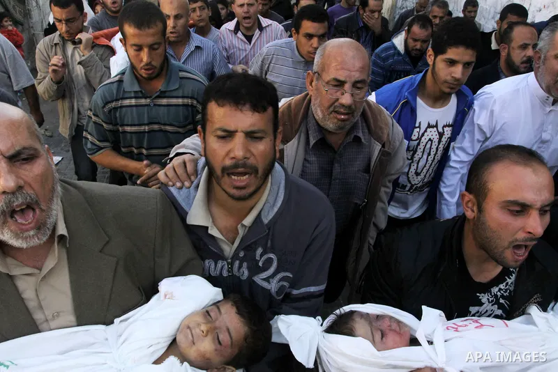 Palestinians carry the bodies of brothers Suhaib, 2-years-old, and Mohammed Hejazi, 4-years-old, during their funeral in the northern Gaza Strip area of Biet Lahia, on November 20, 2012. Four members of the Hejazi family...