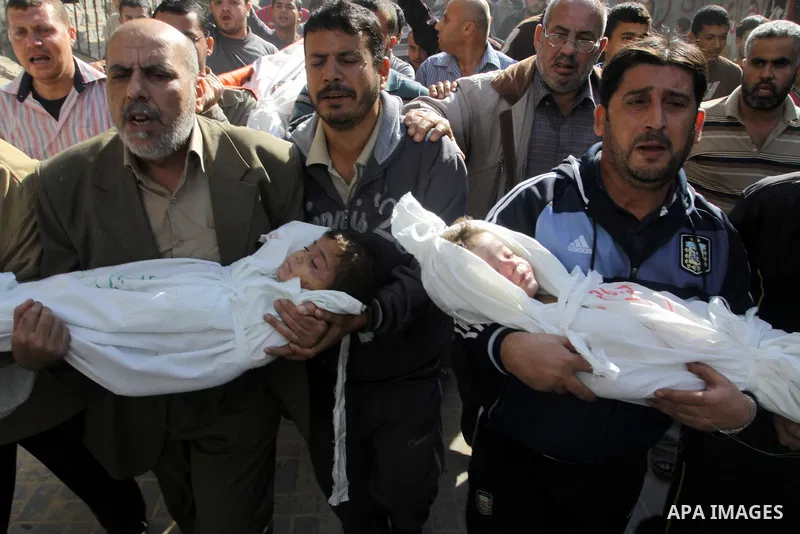Palestinians carry the bodies of brothers Suhaib, 2-years-old, and Mohammed Hejazi, 4-years-old, during their funeral in the northern Gaza Strip area of Biet Lahia, on November 20, 2012. Four members of the Hejazi family...
